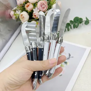 Close-up of professional stainless steel cheese and butter knives with ergonomic handles