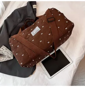 Brown quilted travel duffle bag with cute bow pattern, lightweight crossbody fitness bag.