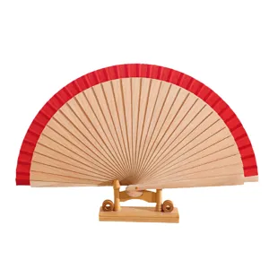 Traditional 23cm Spanish solid wood folding fan with red fabric trim on wooden stand
