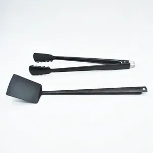 Close-up of professional 2-piece black BBQ tool set including long handle tongs and spatula
