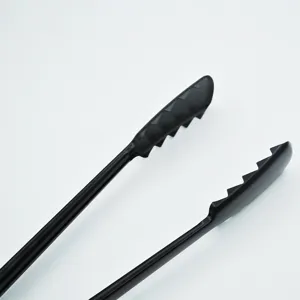 Macro detail of black non-stick long-handled BBQ tongs with scalloped head design