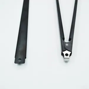 Detail view of the black non-stick long-handled BBQ tongs and spatula accessory set