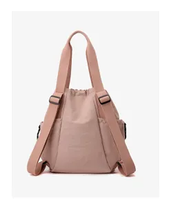 Back view of lightweight pink nylon backpack with adjustable straps and side pockets.