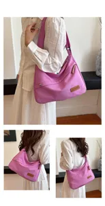 Grand sac à bandoulière en toile rose décontracté porté par un mannequin en robe