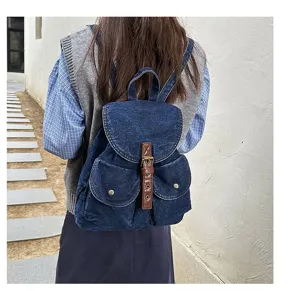 Rear view of a stylish denim backpack for women, perfect for casual school and travel use