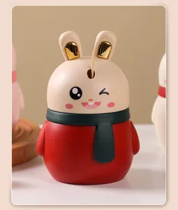 Close-up of a cute rabbit-shaped automatic toothpick dispenser with red body and scarf detail
