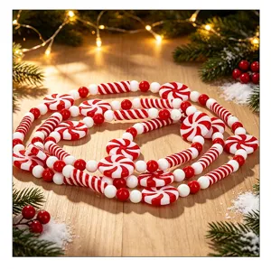 Red and white Christmas candy bead garland decoration displayed on a festive wooden surface