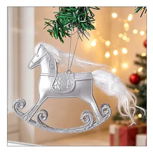 Silver rocking horse Christmas ornament hanging on a tree with white synthetic fur tail