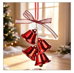 Close-up detail of shiny red metallic Christmas bells with a festive striped ribbon bow