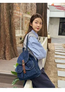 Premium vintage blue denim backpack for school and casual daily use worn by a model outdoors