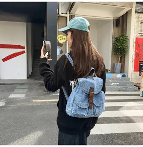 Back view of a casual washed denim backpack for women, perfect for students and daily travel