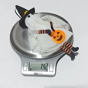 Weight measurement of a cute Halloween ghost ornament on a digital scale, 14.2g