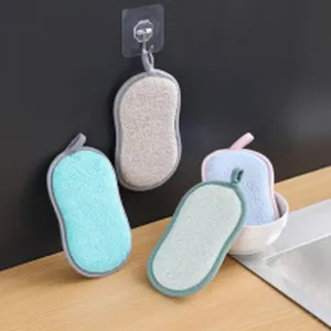 Set of colorful textured dishcloths with hanging loops displayed in a kitchen sink.