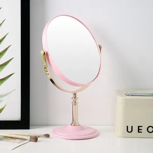 Elegant pink and gold double-sided rotating vanity mirror for desktop makeup application