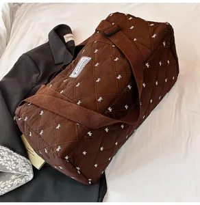 Brown quilted travel duffel bag with white bow pattern, casual gym handbag and shoulder bag.