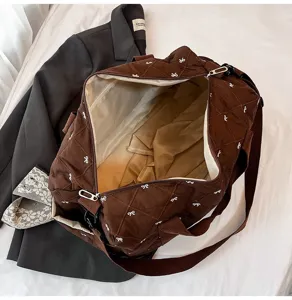 Brown quilted travel duffel bag with white bow pattern, lightweight gym shoulder bag.