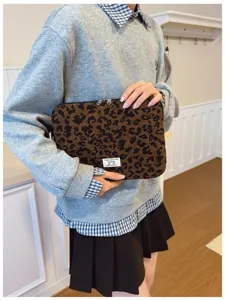 Woman holding leopard print laptop sleeve in corduroy fabric for a cozy lifestyle display
