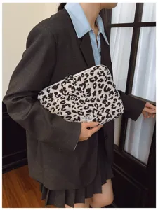 Stylish black and white leopard print laptop sleeve held by a person for display purposes