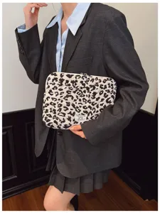 Leopard print quilted laptop sleeve carried by model for tablet storage.
