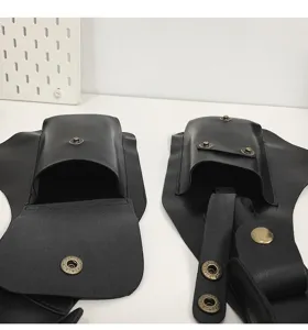 Close-up detail of black leather invisible vest holster bag with bronze snap buttons.