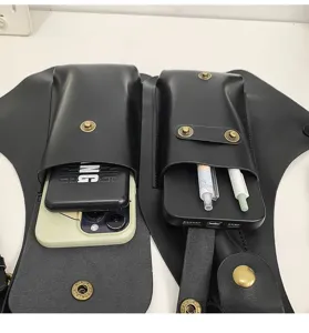 Detail view of black leather underarm holster bag showing phone and pen storage
