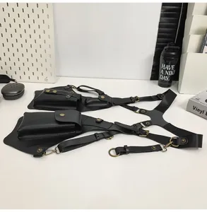 Detail view of dual pouch black tactical shoulder harness bag with adjustable straps