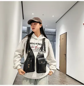 Model wearing a black tactical chest vest bag for urban riding and phone storage.
