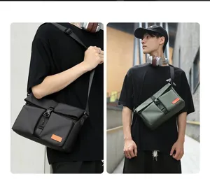 Urban men's waterproof coated messenger bag in black and olive green for commuting