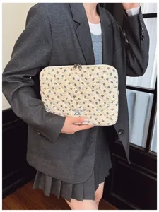 Elegant floral quilted laptop sleeve bag for 11 to 15 inch laptops held by a model