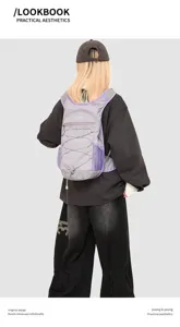 Back view of a lightweight purple outdoor hiking backpack worn by a model in black outfit