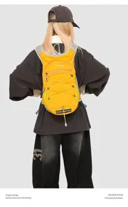 Back view of a lightweight yellow hiking backpack worn by a model in casual wear.