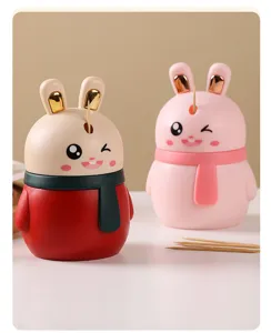 Detailed view of two cute rabbit-shaped automatic toothpick dispensers in red and pink