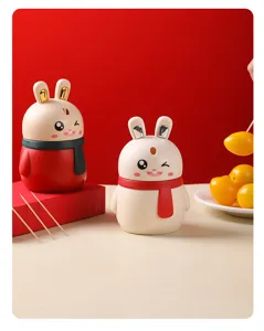Close-up of cute rabbit-shaped automatic toothpick holders on a festive red background