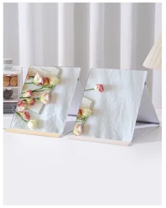 Elegant white folding desktop makeup mirrors presented in a bright minimalist room setting