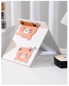 Close-up of portable cute bear folding makeup mirror for student desk