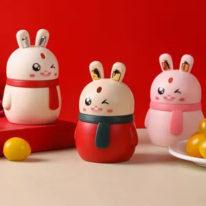 Three cute cartoon bunny automatic toothpick dispensers in red and pink colors