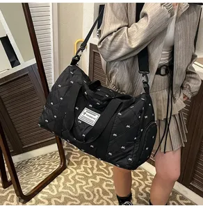 Quilted travel duffel bag with cute bow pattern, lightweight and durable for short trips.