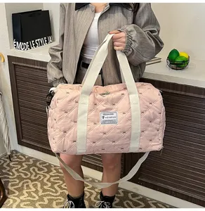 Pink quilted travel duffel bag lightweight short trip gym bag with stylish bow patterns and straps.