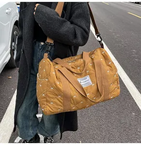 Quilted travel duffel bag for women, lightweight waterproof weekender bag with cute bow patterns.