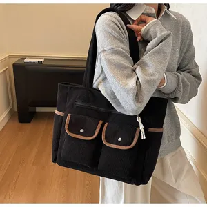 Black large capacity corduroy tote bag for women, stylish commuter shoulder handbag.