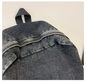 Close-up detail of durable denim backpack showing high-quality stitching and texture