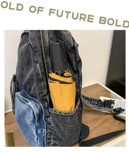 Detail view showing a denim backpack side pocket holding a yellow compact umbrella.