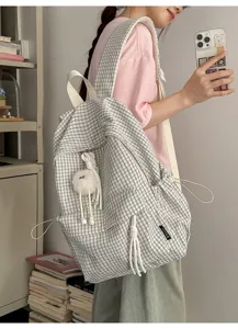 Close-up of a Japanese style checkered backpack worn by a student in a casual setting