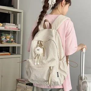 Stylish Japanese style plaid backpack for women with cute plush charm in minimalist design