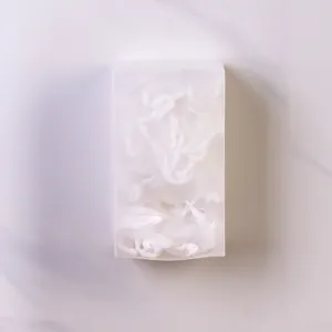 Frosted plastic storage box filled with white fine mesh kitchen sink filters