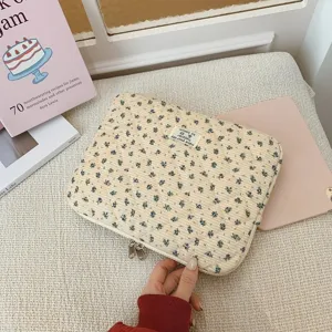 Chic floral quilted laptop sleeve in cream and blue, suitable for 11 to 15 inch laptops