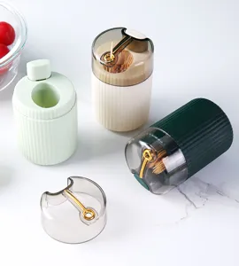 Close-up of three portable push-button toothpick holders in light green and cream finishes.
