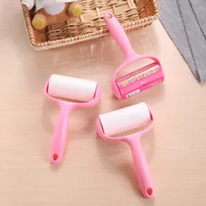 Close-up of pink handheld lint rollers for efficient clothes dust and hair removal