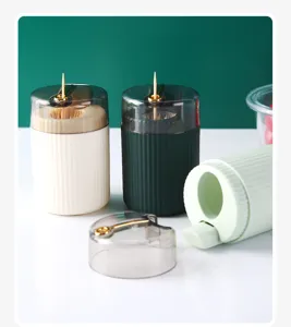 Detail view of portable press-type plastic toothpick dispensers in various colors.