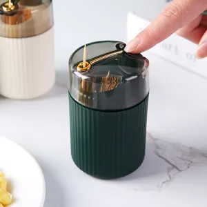 Luxury automatic press-type toothpick holder in dark green with ribbed texture and gold trim